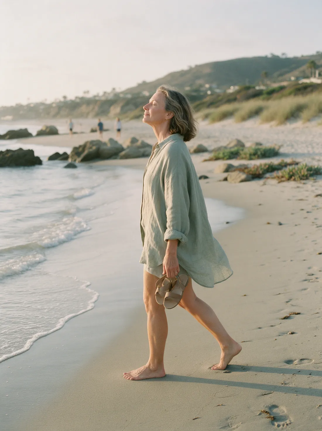 A family caregiver taking a restful walk on the beach